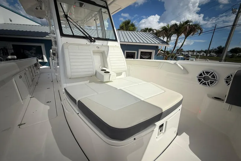 Slide: The Image of 2022 Edgewater 340CC boat interior with cushioned seating and modern design. - 46