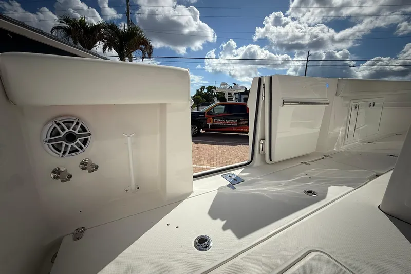 Slide: The Image of 2022 Edgewater 340CC boat interior with speaker and storage compartments. - 20