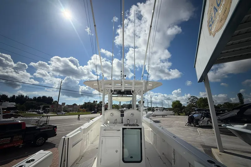 Slide: The Image of 2022 Edgewater 340CC boat under a bright sky at a marina. - 8