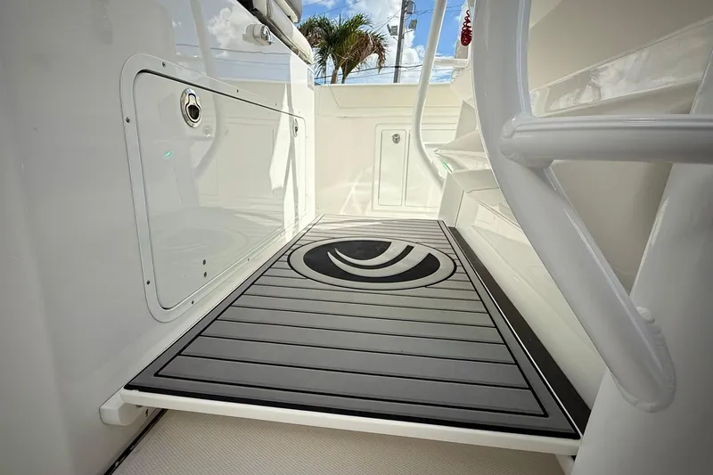 Slide: The Image of Edgewater 340CC 2022 boat interior with sleek flooring and storage compartments. - 33