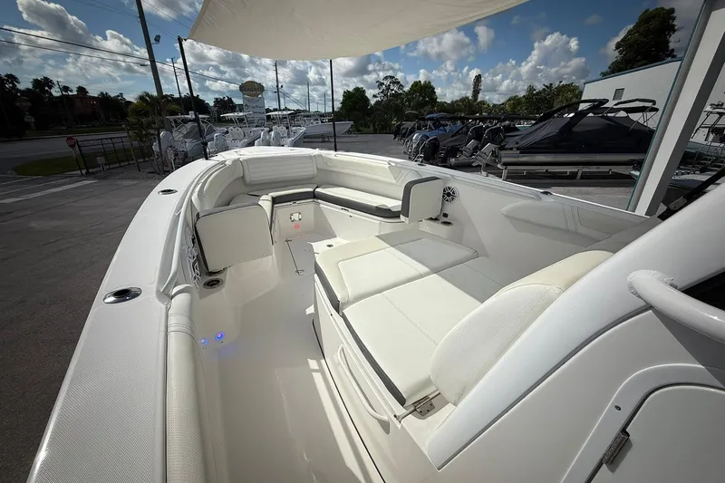 Slide: The Image of 2022 Edgewater 340CC boat interior with white seating and modern design. - 40
