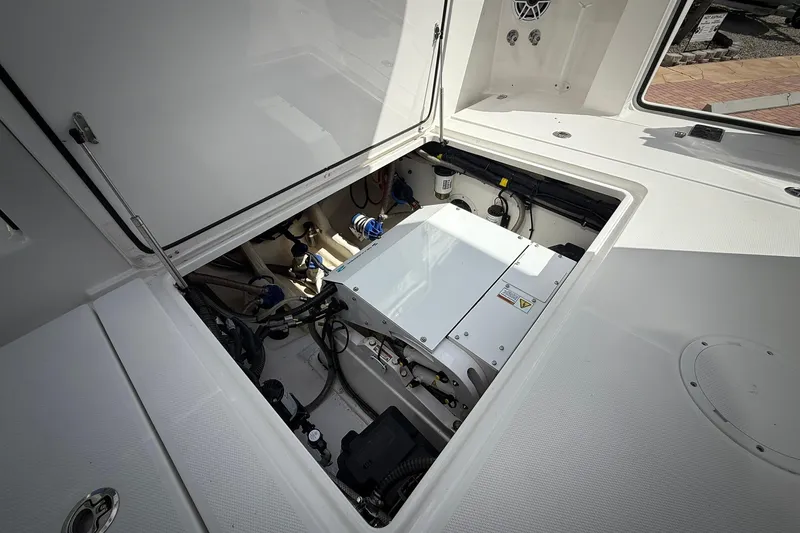 Slide: The Image of Engine compartment of 2022 Edgewater 340CC boat, showcasing internal components and wiring. - 18