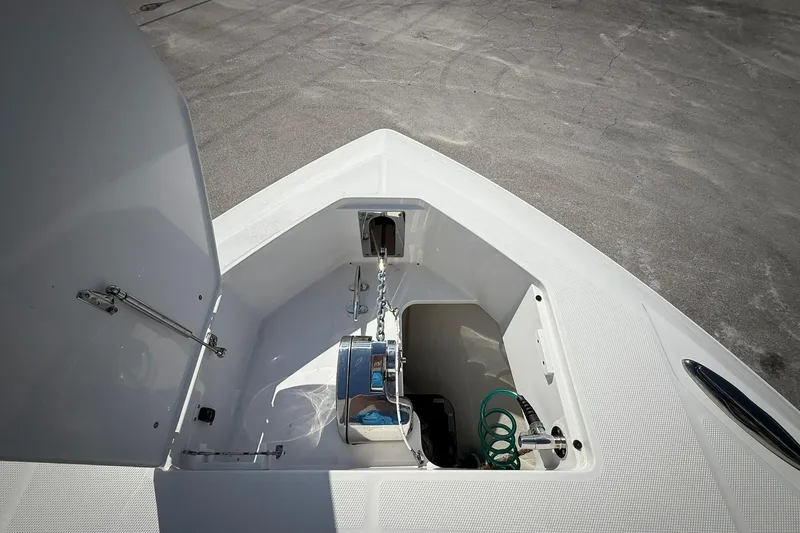 Slide: The Image of Anchor compartment of 2022 Edgewater 340CC boat, featuring chain and storage space. - 44
