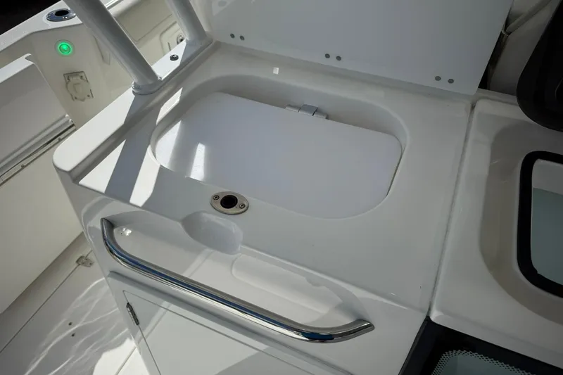 Slide: The Image of 2022 Edgewater 340CC boat sink and storage area, featuring sleek design and functionality. - 13
