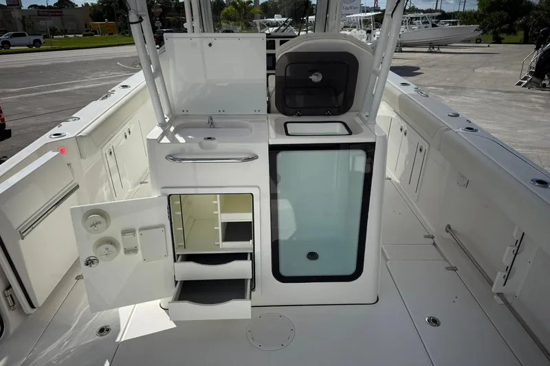 Slide: The Image of 2022 Edgewater 340CC boat interior with storage compartments and sink. - 11