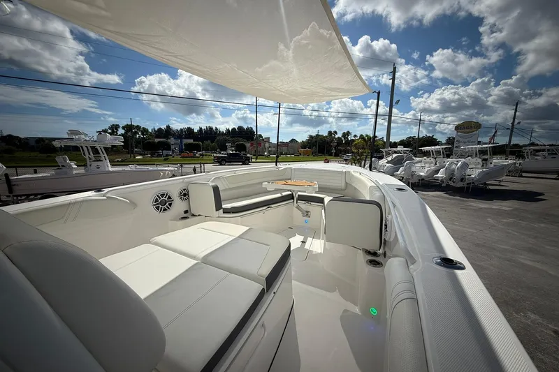 Slide: The Image of 2022 Edgewater 340CC boat interior with seating, under a sunny sky. - 39