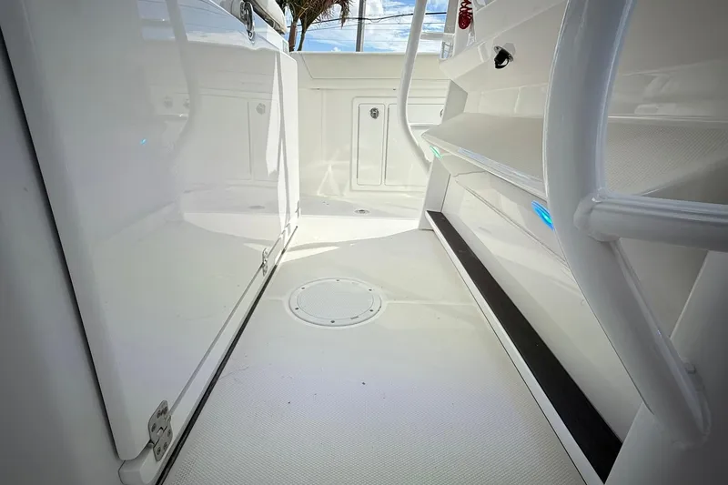 Slide: The Image of 2022 Edgewater 340CC boat interior, featuring sleek white design and modern amenities. - 34