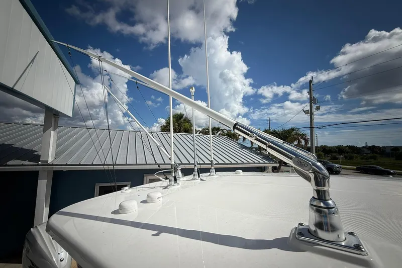 Slide: The Image of 2022 Edgewater 340CC boat with TACO marine hardware under a partly cloudy sky. - 53