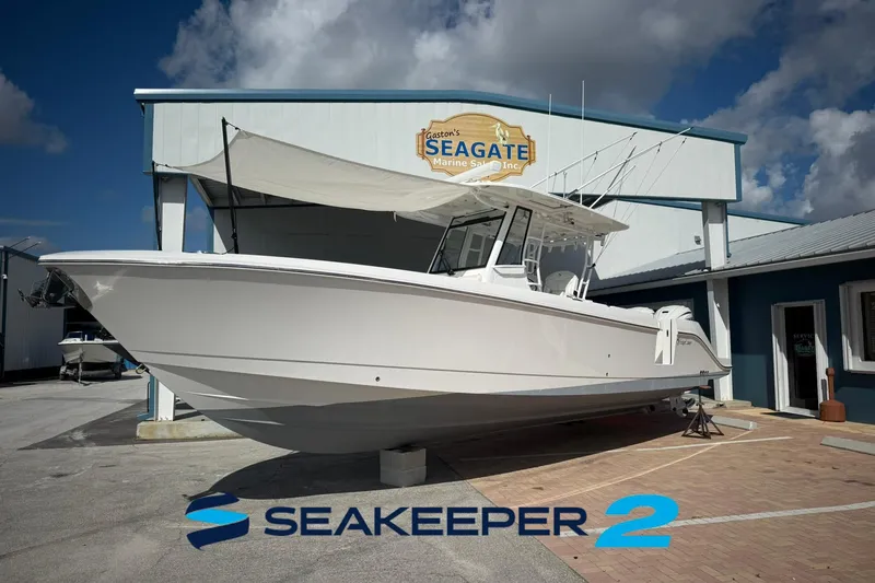 Slide: The Image of 2022 Edgewater 340CC boat displayed at Seagate Marine Sales with Seakeeper 2 logo. - 54