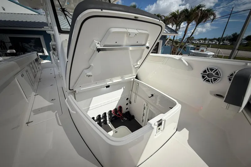 Slide: The Image of Open storage compartment on 2022 Edgewater 340CC boat, showcasing spacious interior design. - 48