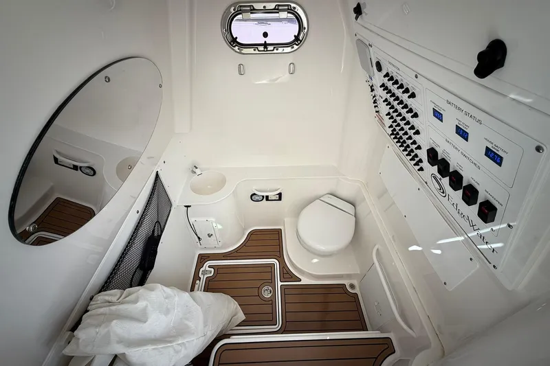 Slide: The Image of Interior of 2022 Edgewater 340CC boat featuring control panel, toilet, and mirror. - 37