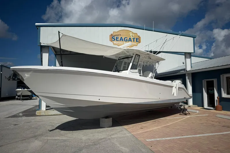 The Image of 2022 Edgewater 340CC boat displayed at Seagate Marine Sales under a clear sky. - 0