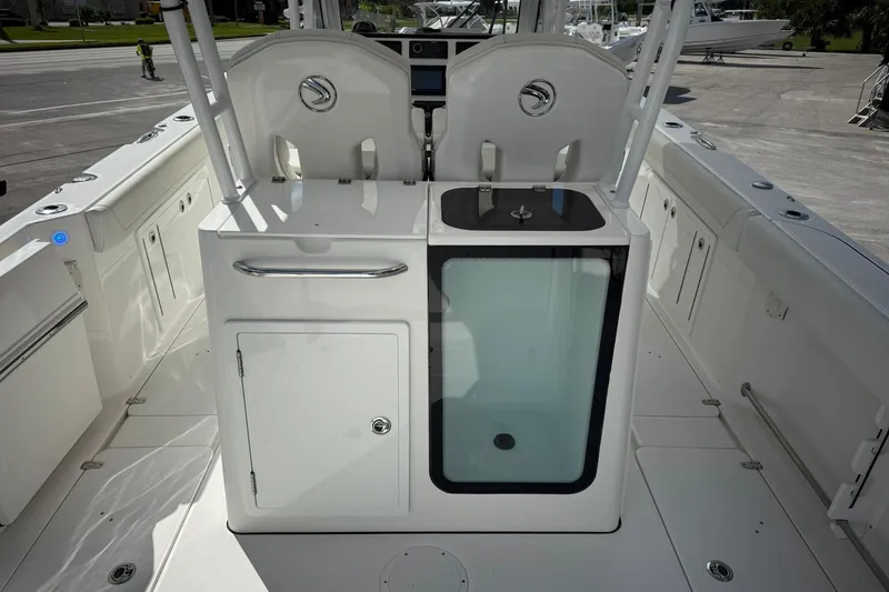 Slide: The Image of 2022 Edgewater 340CC boat interior with seating and storage compartments. - 10