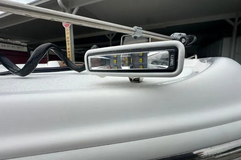 Slide: The Image of Close-up of a 2024 NauticStar 211 Hybrid boat's LED light fixture. - 23