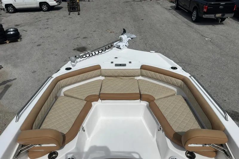 Slide: The Image of 2024 NauticStar 211 Hybrid boat with tan cushioned seating and modern design. - 6