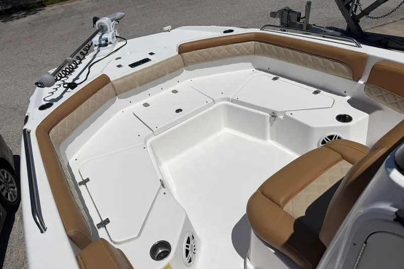 Slide: The Image of 2024 NauticStar 211 Hybrid boat interior with tan seating and storage compartments. - 7
