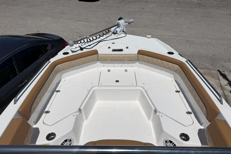 Slide: The Image of 2024 NauticStar 211 Hybrid boat interior with tan seating and white deck. - 5