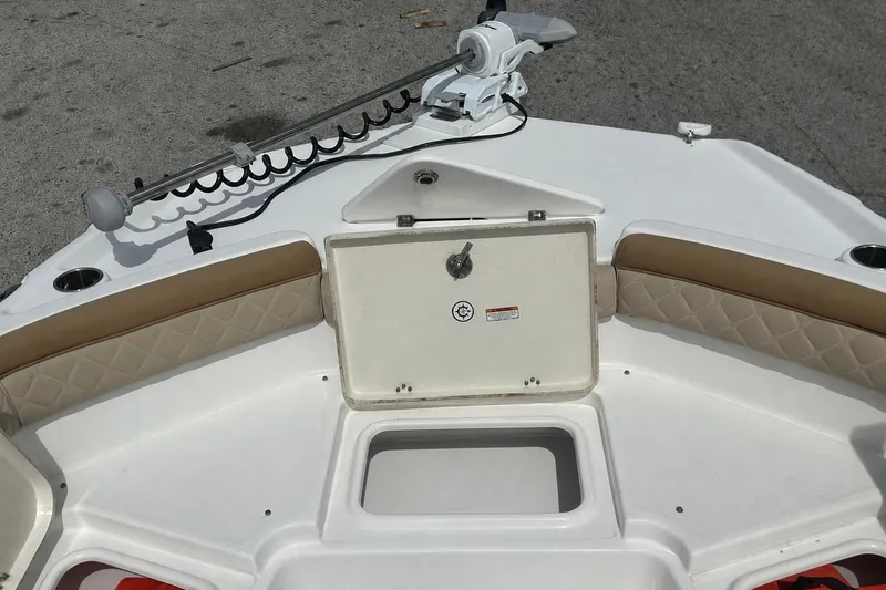 Slide: The Image of 2024 NauticStar 211 Hybrid boat interior with storage compartment and cushioned seating. - 4