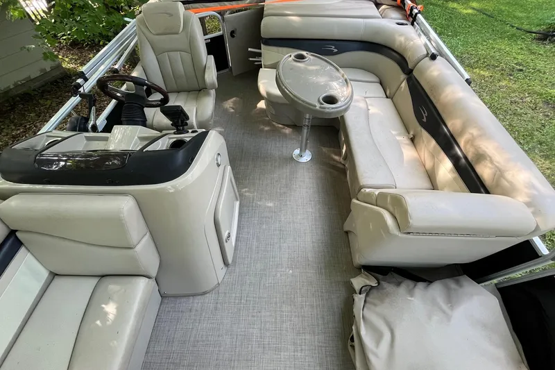 Slide: The Image of 2016 Bennington SX 20 pontoon boat interior with beige seating and steering console. - 19
