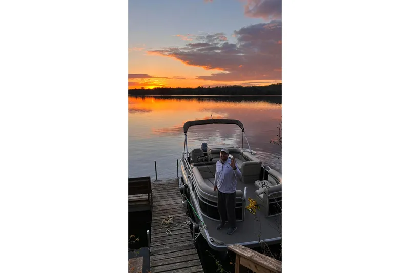 Slide: The Image of 2016 Bennington SX 20 pontoon boat docked at sunset on a serene lake. - 3