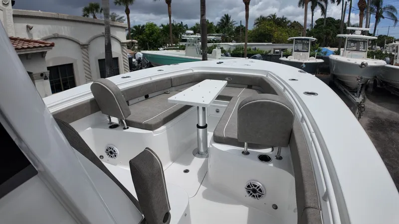 Slide: The Image of The image shows the bow of a Sea Hunt Gamefish 30 with gray seating and a table. - 32
