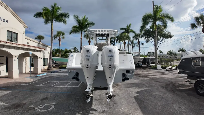 Slide: The Image of A Sea Hunt Gamefish 30 boat with twin outboard engines is parked in a lot. - 3