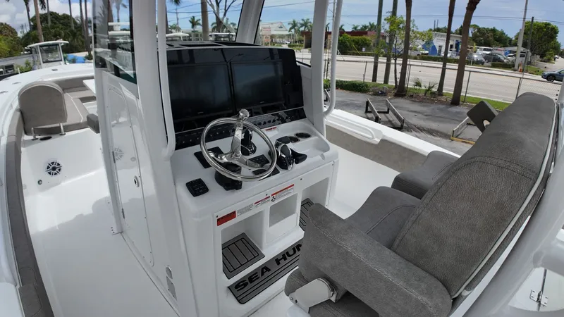 Slide: The Image of The image shows the cockpit of a Sea Hunt Gamefish 30 with gray seats and modern electronics. - 17
