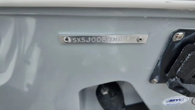 Slide: The Image of Close-up of a boat hull identification number on a gray surface. - 48