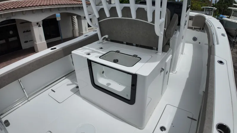 Slide: The Image of The image shows the deck of a Sea Hunt Gamefish 30 with seating and a central console. - 21