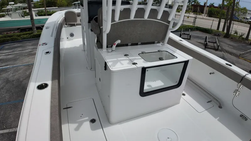 Slide: The Image of The image shows the deck of a Sea Hunt Gamefish 30 with seating and storage. - 22