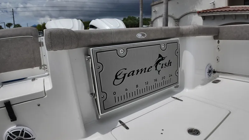 Slide: The Image of The image shows the stern of a Sea Hunt Gamefish 30 with gray upholstery and a measuring scale. - 12
