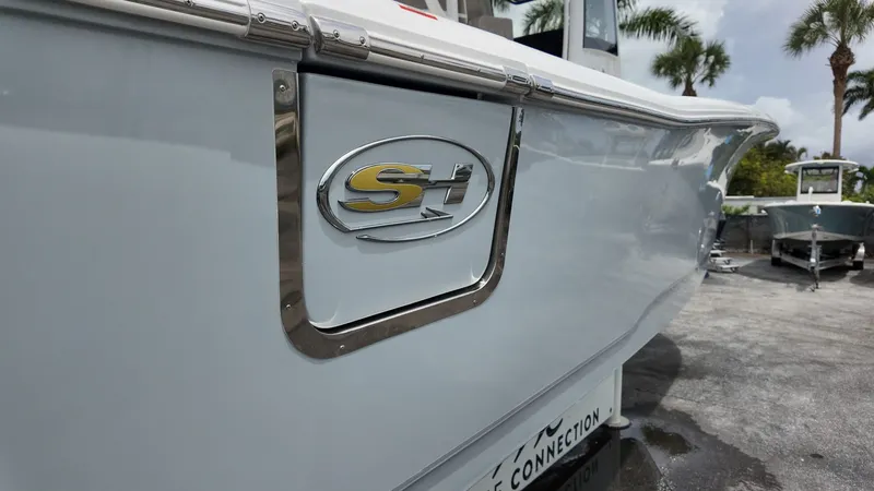 Slide: The Image of Sea Hunt Gamefish 30 with sleek side view and logo, parked on a lot. - 46