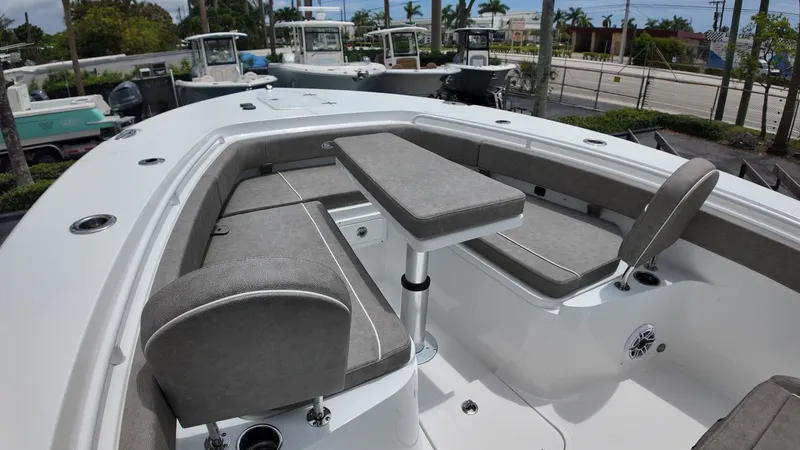 Slide: The Image of The image shows the forward seating area of a Sea Hunt Gamefish 30 boat with gray cushions. - 38