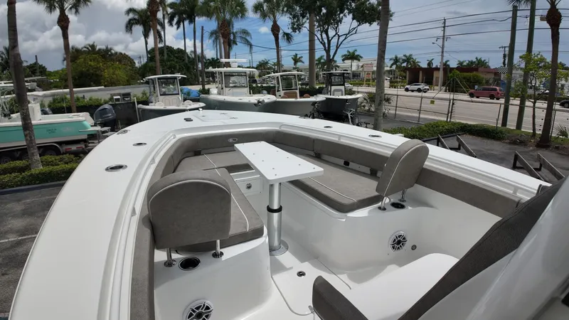 Slide: The Image of The image shows a Sea Hunt Gamefish 30 boat with forward seating, surrounded by palm trees. - 31