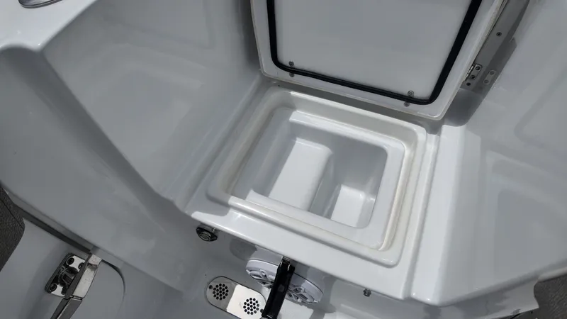 Slide: The Image of An open storage compartment on a boat with a gray floor and drain. - 13