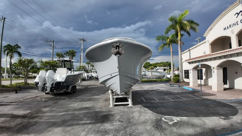 Slide: The Image of A Sea Hunt Gamefish 30 Forward Seating boat is parked on a lot in front of a building. - 6