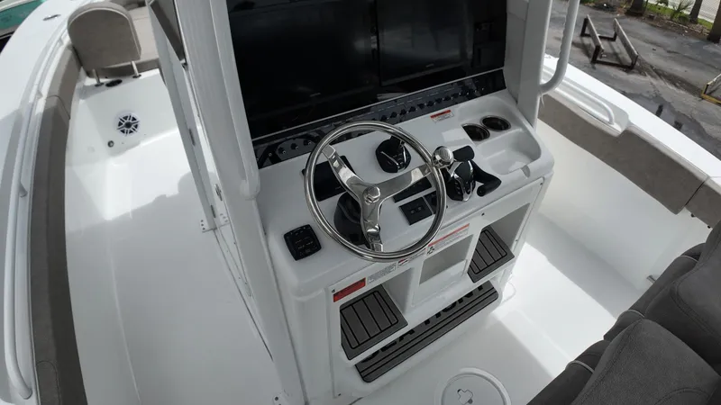 Slide: The Image of The image shows the helm of a Sea Hunt Gamefish 30 with modern controls and a large screen. - 29