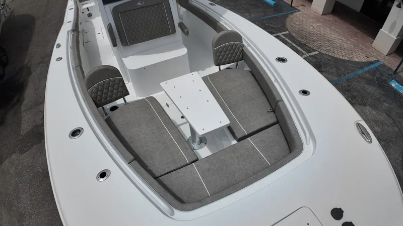 Slide: The Image of The image shows the forward seating area of a Sea Hunt Gamefish 30 boat with gray cushions. - 39