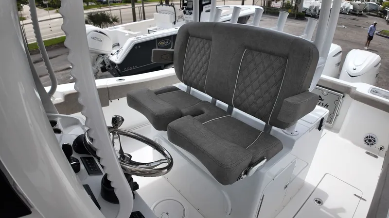 Slide: The Image of The image shows the helm of a Sea Hunt Gamefish 30 with gray upholstered seats. - 24