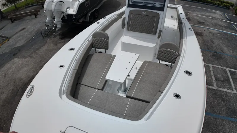 Slide: The Image of The image shows a Sea Hunt Gamefish 30 boat with gray upholstery and a spacious deck. - 36