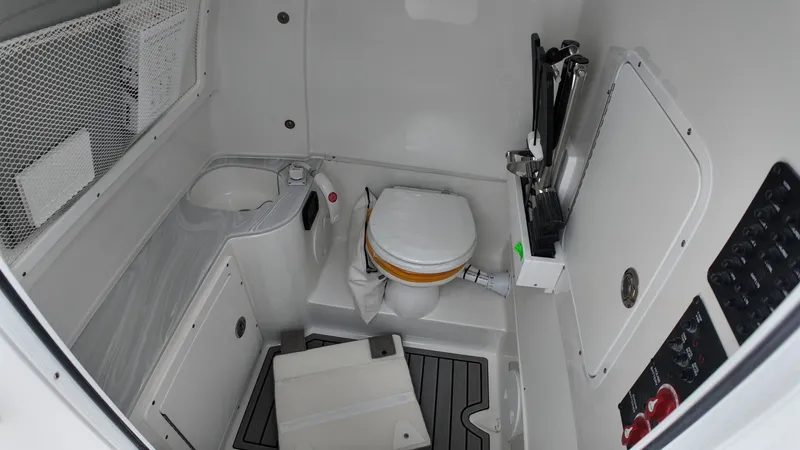 Slide: The Image of Interior of a boat cabin with a toilet and storage space. - 40