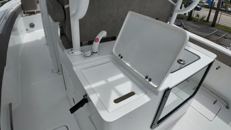 Slide: The Image of The image shows a white boat galley with a sink and storage area. - 19