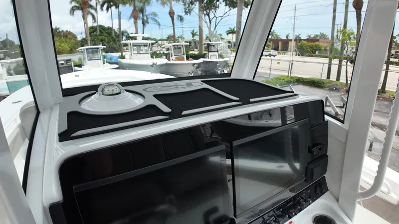 Slide: The Image of The image shows the cockpit of a Sea Hunt Gamefish 30 with modern navigation systems. - 30
