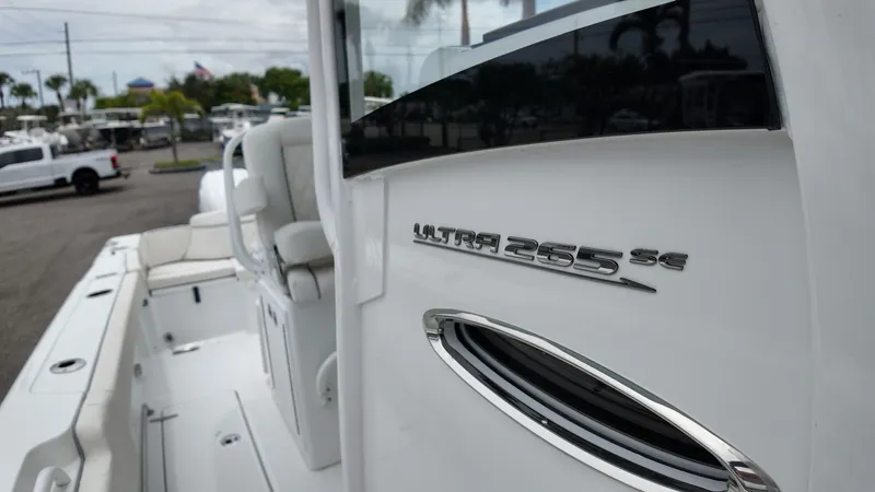 Slide: The Image of Close-up of the Sea Hunt Ultra 265 SE boat with a shiny logo. - 49
