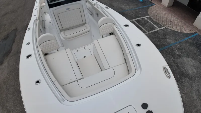 Slide: The Image of The image shows the deck of a 2027 Sea Hunt Ultra 265 SE boat with cushioned seating. - 42