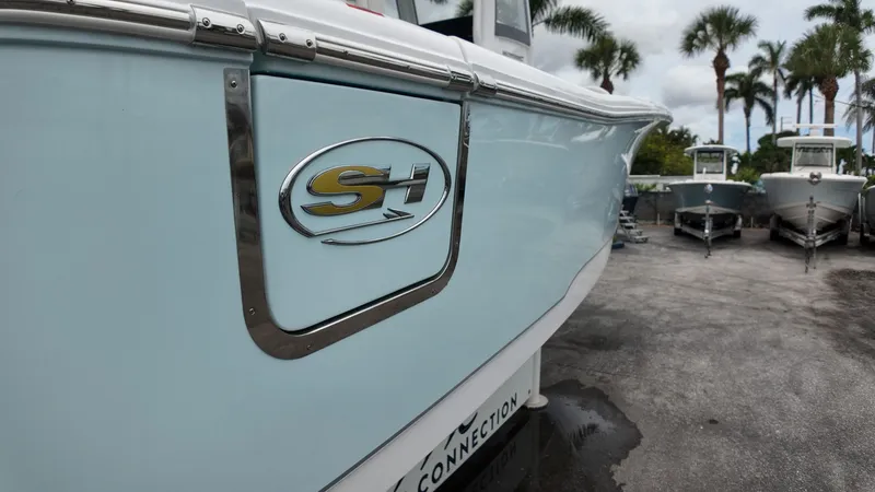 Slide: The Image of The image shows a 2027 Sea Hunt Ultra 265 SE boat on land. - 8