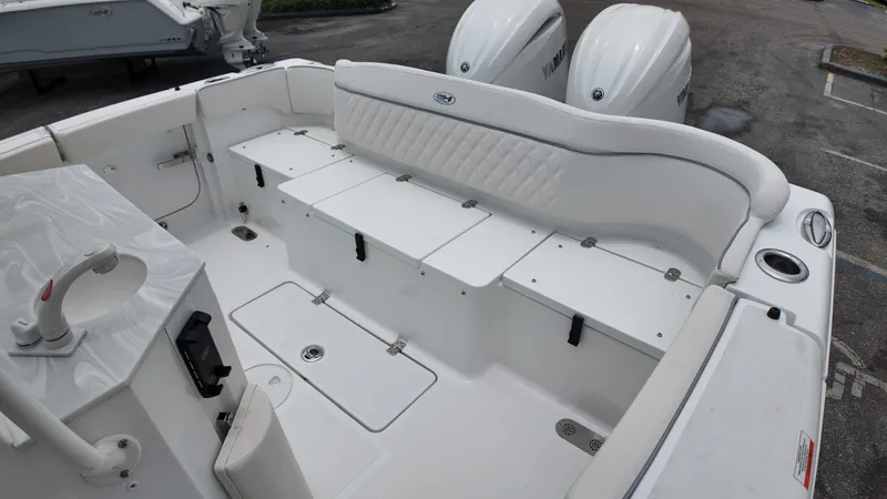 Slide: The Image of The image shows the stern of a Sea Hunt Ultra 265 SE boat with two engines. - 12