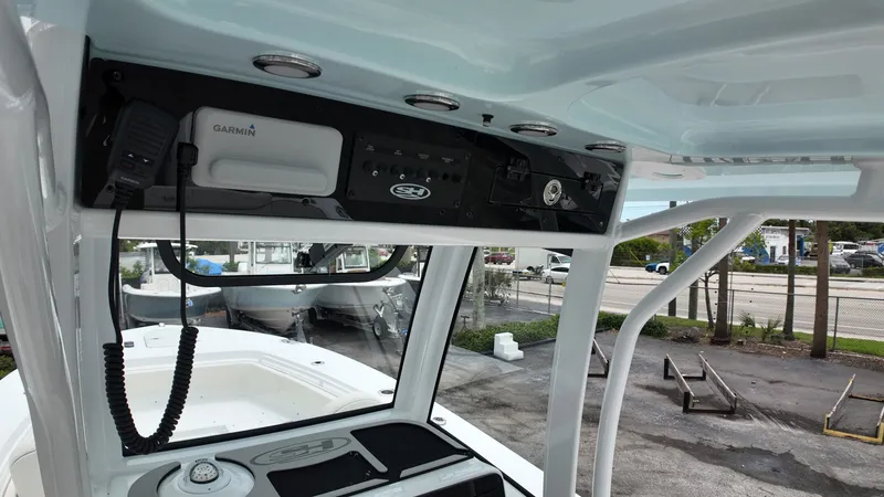 Slide: The Image of The image shows the helm of a Sea Hunt Ultra 265 SE boat with modern electronics. - 31