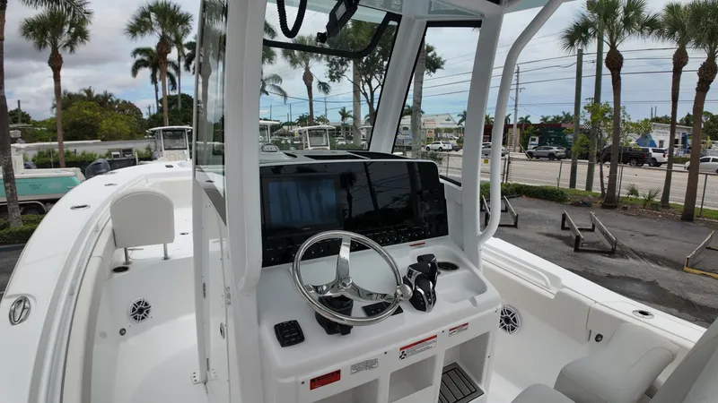 Slide: The Image of The image shows the helm of a 2027 Sea Hunt Ultra 265 SE boat. - 24