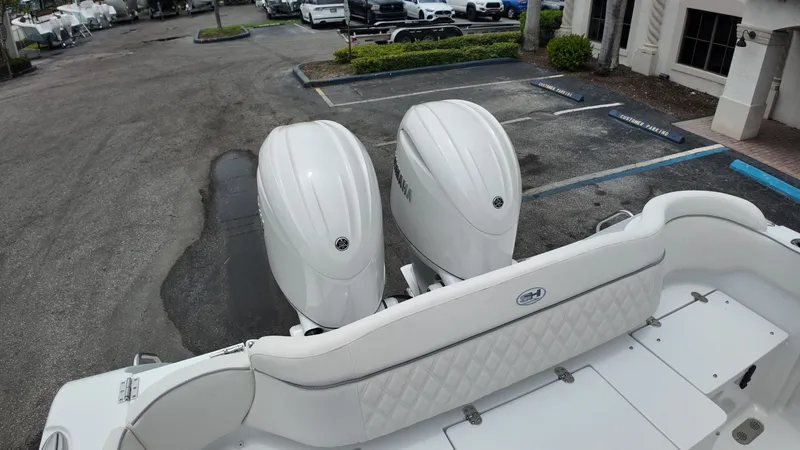 Slide: The Image of Two large outboard engines are mounted on the stern of a boat parked in a lot. - 9